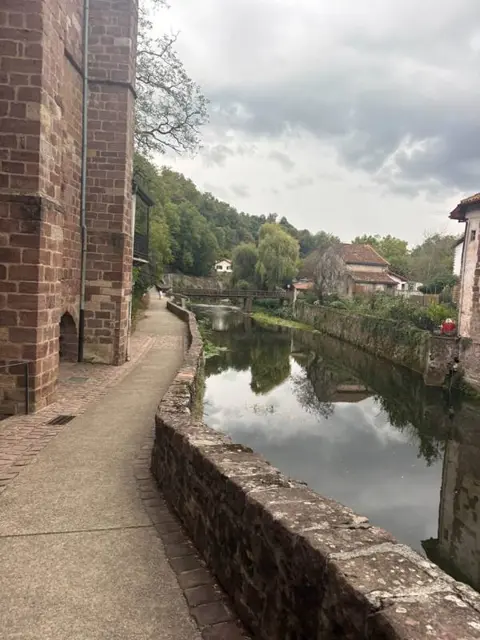 Sendero junto al río Nive y muros de arenisca rosa